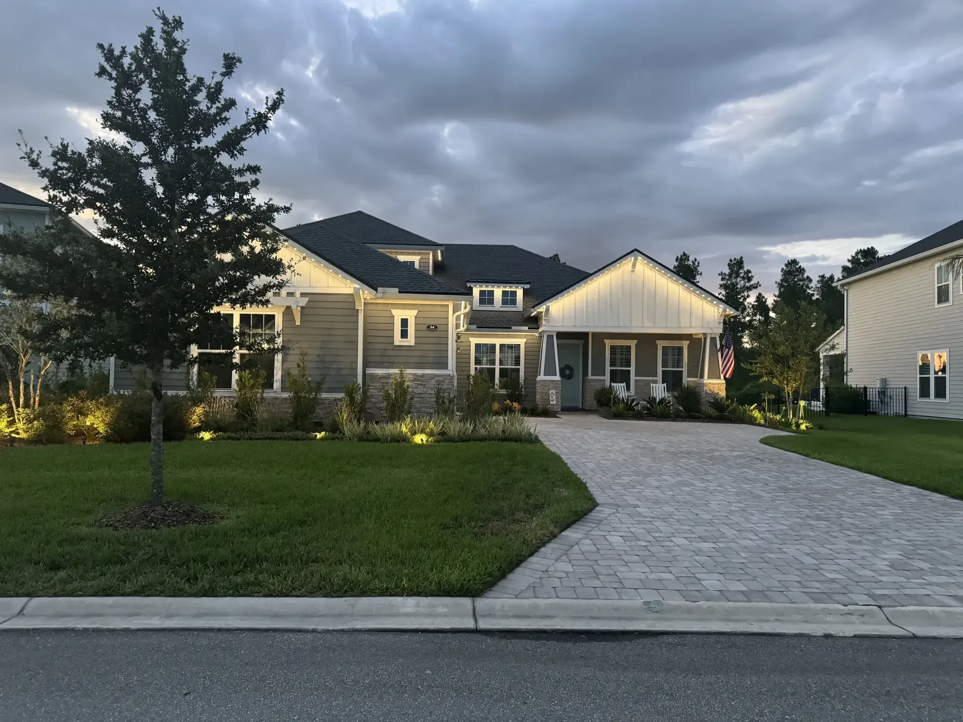 Single-story Florida home at dusk with warm white Jellyfish lights along the roofline