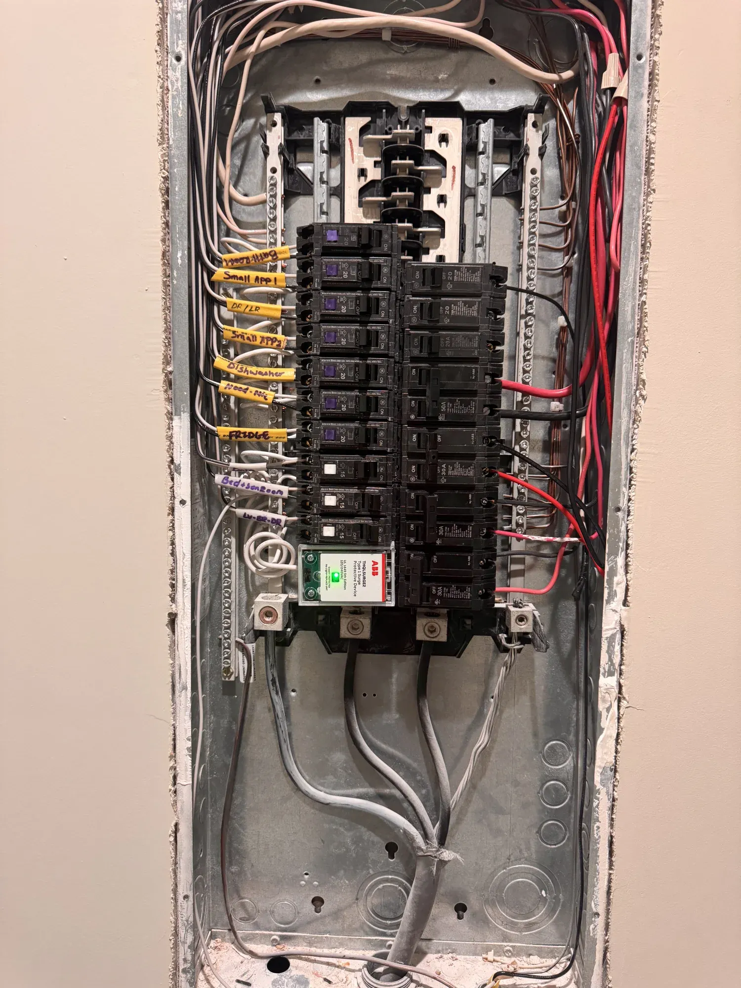 Open electrical panel with new breakers and neatly dressed wiring