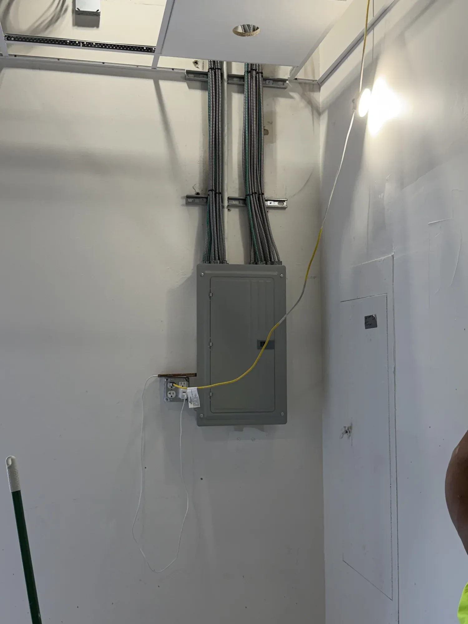 New subpanel with conduit runs mounted on a clean garage wall