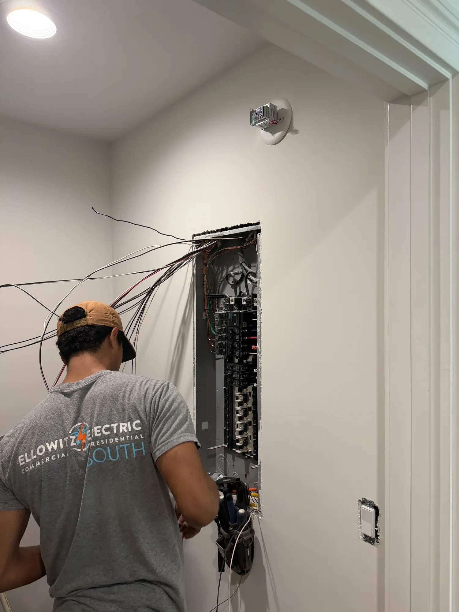 Ellowitz Electric South electrician wiring a new panel in a utility room