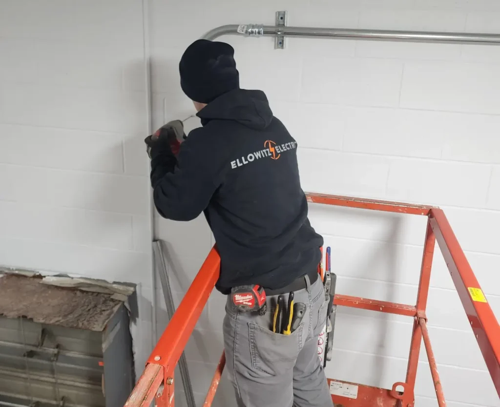 Electrician installing pipes for electrical wiring