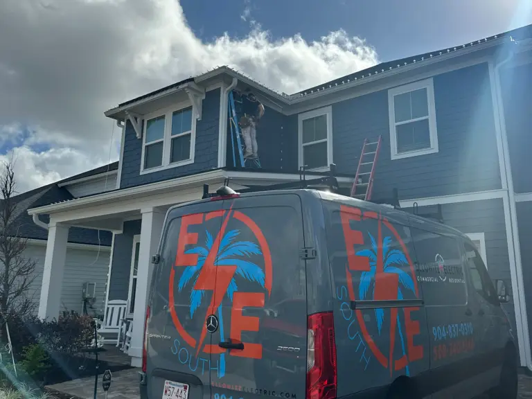 Electrician on ladder installing jellyfish lighting.